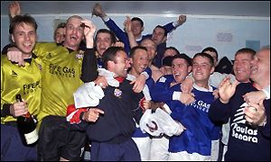 The promotion winning squad find time for some celebrations after the Brechin City match.